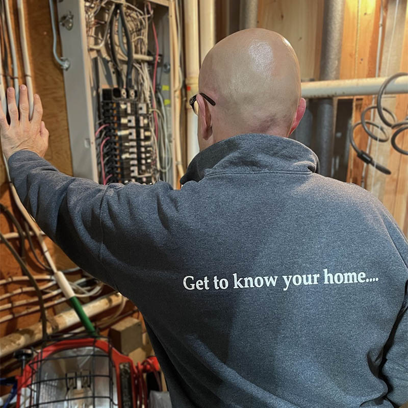 Inspector Walt looking at an electrical panel during a home inspection 