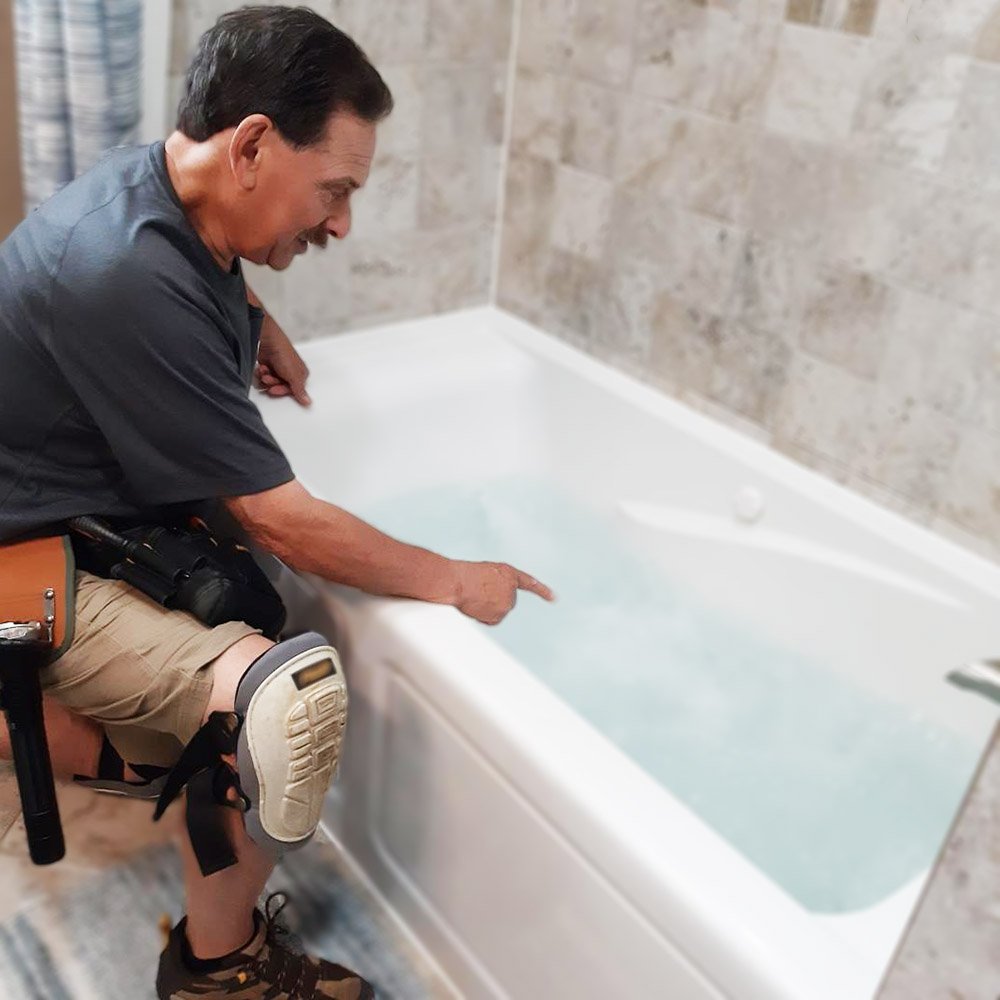 Steve pointing to a bathtub during a home inspection 